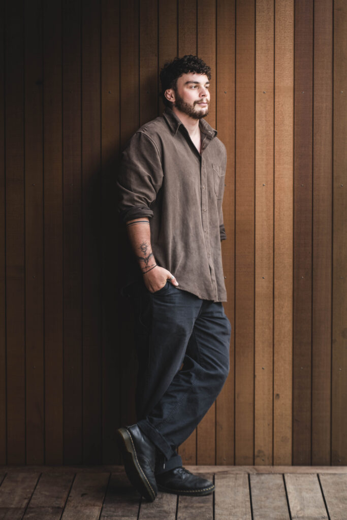 Man leans against timber exterior wall | George on the VOID team